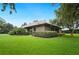 Beautifully landscaped backyard featuring mature trees and a well-maintained lawn at 105 Woden Way, Winter Haven, FL 33884