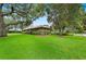 Charming exterior view of home featuring lush lawn, mature trees, and a well-manicured landscape at 105 Woden Way, Winter Haven, FL 33884