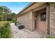 Side exterior view of home with brick, AC units, and privacy fence at 105 Woden Way, Winter Haven, FL 33884