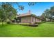 Brick exterior showcasing the rear of the home with tidy landscaping and a well-maintained lawn at 105 Woden Way, Winter Haven, FL 33884