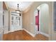 Foyer with hardwood floors, white trim, and an arched doorway leading into another room at 105 Woden Way, Winter Haven, FL 33884
