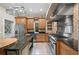 Gourmet kitchen with stainless steel appliances, custom cabinets, and a large island at 105 Woden Way, Winter Haven, FL 33884