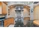 Custom kitchen with stainless steel appliances, granite countertops, and a large island at 105 Woden Way, Winter Haven, FL 33884