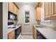 Bright kitchen with stainless steel appliances, wood cabinets, and natural lighting at 105 Woden Way, Winter Haven, FL 33884