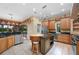 Well-equipped kitchen with stainless steel appliances, custom cabinets, and a prep island at 105 Woden Way, Winter Haven, FL 33884