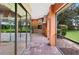 Screened-in patio features an outdoor kitchen and brick fireplace at 105 Woden Way, Winter Haven, FL 33884