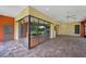 A large screened-in patio with brick floors and floor-to-ceiling glass windows at 105 Woden Way, Winter Haven, FL 33884