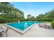 Beautifully maintained community pool surrounded by lush greenery and lounge chairs at 105 Woden Way, Winter Haven, FL 33884