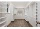 A walk-in closet with carpeted flooring and custom white shelving units at 105 Woden Way, Winter Haven, FL 33884