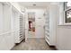 Spacious walk-in closet with custom shelves and view into the bathroom at 105 Woden Way, Winter Haven, FL 33884