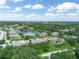 Expansive aerial view of the community with a tranquil lake and lush trees at 1102 Eagle Pond Dr # 1102, Winter Haven, FL 33884