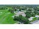 Aerial view of community showcasing the pool, tennis courts and manicured landscaping at 1102 Eagle Pond Dr # 1102, Winter Haven, FL 33884