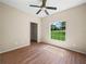 Charming bedroom with a ceiling fan, wood-look floors, and a window providing a view of the lush greenery at 1102 Eagle Pond Dr # 1102, Winter Haven, FL 33884