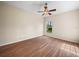 Comfortable bedroom with wood-look floors, a ceiling fan, and a window offering a view at 1102 Eagle Pond Dr # 1102, Winter Haven, FL 33884