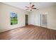 Inviting bedroom with wood-look floors, a ceiling fan, walk-in closet, and attached bathroom at 1102 Eagle Pond Dr # 1102, Winter Haven, FL 33884