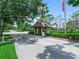 Gated entrance featuring manicured landscaping and an American flag at 1102 Eagle Pond Dr # 1102, Winter Haven, FL 33884