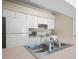 Well-lit kitchen features a refrigerator, microwave, and white cabinets at 1102 Eagle Pond Dr # 1102, Winter Haven, FL 33884