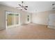Bright living room featuring tile flooring, a ceiling fan, sliding glass doors, and a window for ample natural light at 1102 Eagle Pond Dr # 1102, Winter Haven, FL 33884