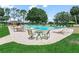 Resort-style community pool with lounge chairs, umbrellas, and a charming poolside seating area at 1102 Eagle Pond Dr # 1102, Winter Haven, FL 33884