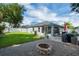 Relaxing backyard with a cozy fire pit and well-maintained landscaping at 124 Eagle Point Blvd, Auburndale, FL 33823