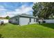 Lush backyard with lawn and access to the house at 124 Eagle Point Blvd, Auburndale, FL 33823