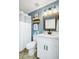 Clean bathroom with white cabinets, stylish mirror, and shower with white curtain at 124 Eagle Point Blvd, Auburndale, FL 33823