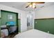 Bedroom featuring a built-in desk, accent wall, and en-suite bathroom access at 124 Eagle Point Blvd, Auburndale, FL 33823