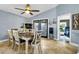 Bright dining area with a ceiling fan, seating for six, and French doors leading to the outdoor space at 124 Eagle Point Blvd, Auburndale, FL 33823