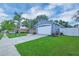 Exterior view of a cozy home with a neat front lawn, a two-car garage, and well-kept landscaping at 124 Eagle Point Blvd, Auburndale, FL 33823
