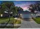 Charming single-story home with a well-maintained lawn and inviting curb appeal under a colorful sunset sky at 124 Eagle Point Blvd, Auburndale, FL 33823