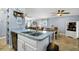 Open-concept kitchen with peninsula island and connection to dining and living areas at 124 Eagle Point Blvd, Auburndale, FL 33823
