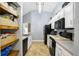 Well-lit kitchen featuring stainless steel appliances and tiled floor at 124 Eagle Point Blvd, Auburndale, FL 33823