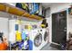 Well-organized laundry area with washer, dryer, and overhead storage to maximize space at 124 Eagle Point Blvd, Auburndale, FL 33823