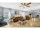 Spacious living room featuring neutral tile floors, ceiling fans, and abundant natural light from the windows at 124 Eagle Point Blvd, Auburndale, FL 33823