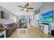 Inviting living room with neutral tile flooring, comfortable seating, and a seamless flow to the dining area at 124 Eagle Point Blvd, Auburndale, FL 33823