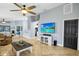 Bright, open-concept living space with tile floors, a ceiling fan, and views into the dining and kitchen areas at 124 Eagle Point Blvd, Auburndale, FL 33823