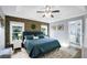 Spacious main bedroom featuring accent wall, ceiling fan, and connecting bath at 124 Eagle Point Blvd, Auburndale, FL 33823
