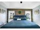 The main bedroom shows accent wall, ceiling fan, and natural light from windows at 124 Eagle Point Blvd, Auburndale, FL 33823