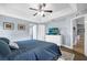 Bright main bedroom with ceiling fan and ensuite bathroom at 124 Eagle Point Blvd, Auburndale, FL 33823