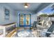 Cozy sunroom boasting french doors, seating, and plenty of natural light at 124 Eagle Point Blvd, Auburndale, FL 33823