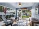 Bright sunroom features large windows, comfortable seating, and backyard views at 124 Eagle Point Blvd, Auburndale, FL 33823