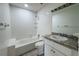 Bathroom featuring tile floors, a bathtub, and a granite countertop at 1476 Avenue F Ne, Winter Haven, FL 33881