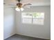 Bright bedroom featuring a ceiling fan and a window providing natural light at 1476 Avenue F Ne, Winter Haven, FL 33881