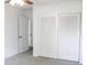 This is a bedroom with gray carpet, white walls, and a ceiling fan with a light at 1476 Avenue F Ne, Winter Haven, FL 33881