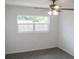 Bedroom featuring carpeted floors, a ceiling fan, and a window at 1476 Avenue F Ne, Winter Haven, FL 33881