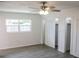 Comfortable bedroom with natural light, ceiling fan, and closet with white louvered doors at 1476 Avenue F Ne, Winter Haven, FL 33881
