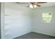 A bedroom features built-in shelves, ceiling fan, and a bright window view at 1476 Avenue F Ne, Winter Haven, FL 33881