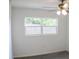 Bright room with neutral paint, carpet, and a ceiling fan with leafy view from window at 1476 Avenue F Ne, Winter Haven, FL 33881