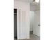 Bedroom with modern gray carpet, with closet with white louvered doors at 1476 Avenue F Ne, Winter Haven, FL 33881