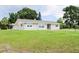 Charming single-story home featuring a well-maintained lawn and neutral-colored exterior at 1476 Avenue F Ne, Winter Haven, FL 33881